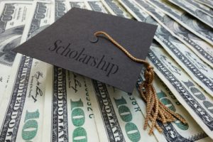 NAHMA Scholarship Represented by graduates cap on money background