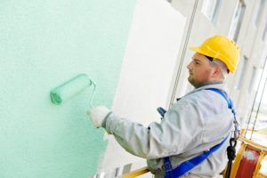 Man Painting Exterior Apartment Building Walls With Roller Brush Hiring Apartment Painting Contractors