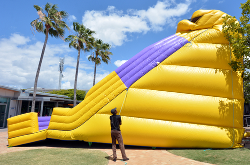 Worker Inflates Giant Bouncy Castle At Kids Related Apartment Resident Events