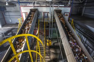 Trash And Recycling Moving On Conveyors During A Waste Management Audit