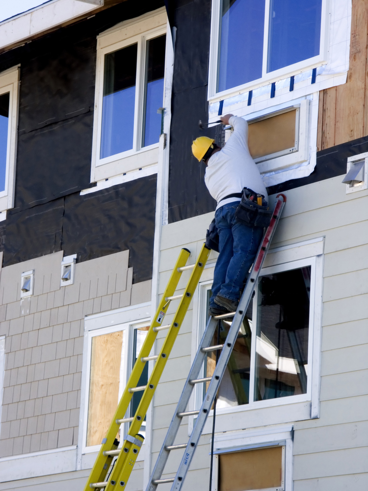 Man Installing New Commercial Siding As An Example of Great CapEx Projects for Commercial Properties