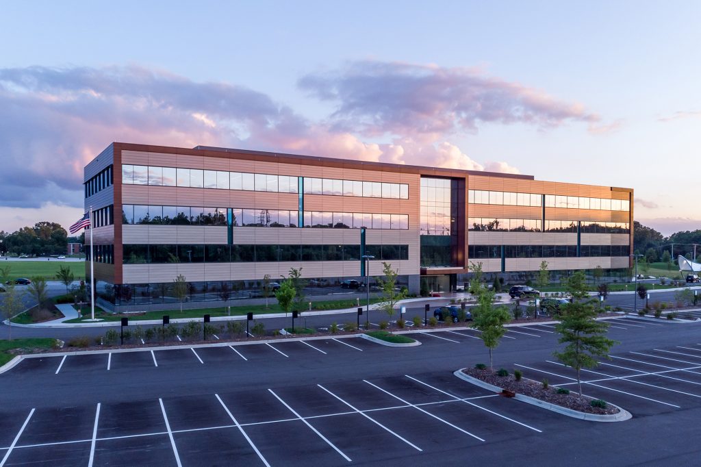 Mid Rise Class A Office Building and Parking Lot At Sunset That Can Benefit From Six Tips for Preventive Maintenance of Commercial Property Properties
