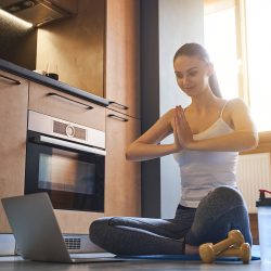Yoga Instructor Leading Class From An Apartment - Virtual Resident Events For Apartment Managers