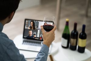 Man Participating In A Virtual Wine Tasting At Laptop With 3 Bottles of Wine For Socially Distanced Resident Events For Winter 2021 Blog