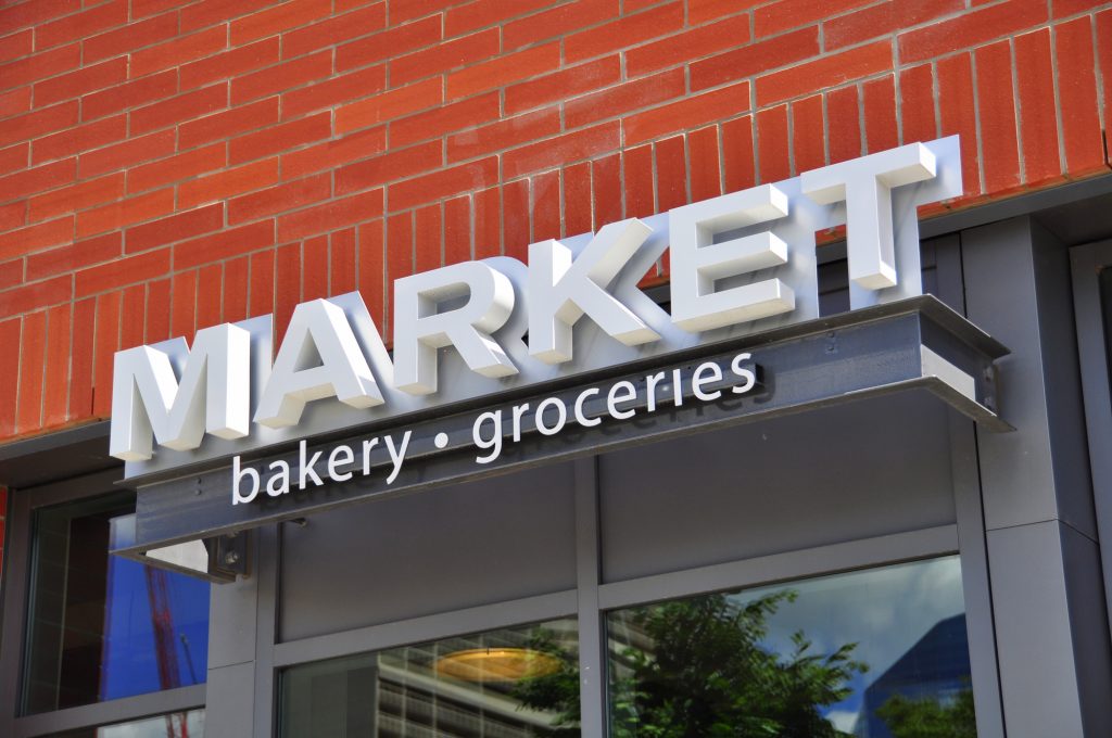 Market Bakery and Groceries in Metal Channel Letters Attached To Brick Building