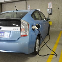 Electric Vehicle Chargng At EV Charging Station In Commercial Parking Garage