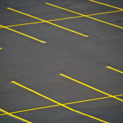 Asphalt Emulsion Type of Sealcoat On Commercial Parking Lot With Yellow Line Striping