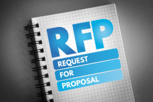 RFP Request For Proposal In Blue On Front Of Notebook For Property Manager Insider