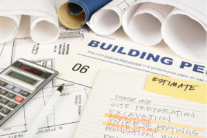 Commercial Construction Plans Permits And Estimates On Work Bench