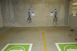 Commercial EV Charging Stations At Dedicated Spots In Apartment Parking Garage