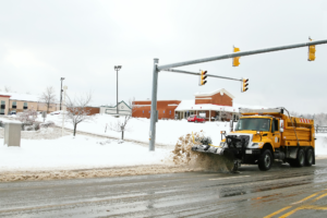 Snow Plow Removing Snow Keeping Essential Retail Stores Open During Snow Events