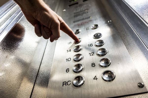 passenger pressing elevator button