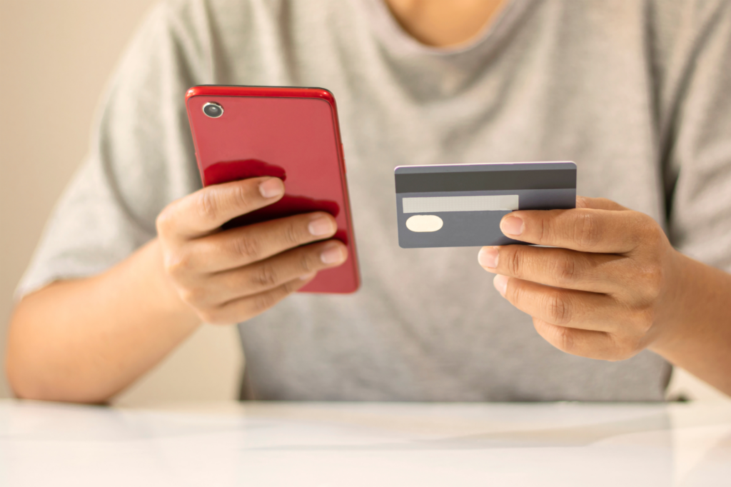 Man Setting Up Electronic Payment On Phone With Bank Card